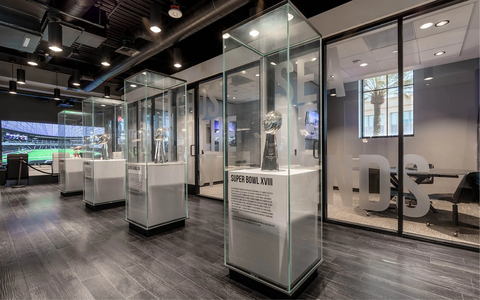 The Raiders' three super bowl trophies are displayed to make an impactful statement about the legacy of the franchise. The trophies are positioned just outside the closing rooms of the sales center.