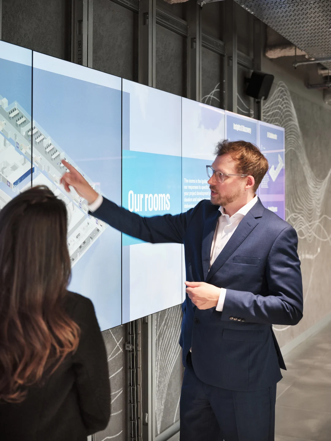 The branded motion graphics extend to the next digital touchpoint and serve as an ambient media backdrop to support key messaging. The particle-wave reveals provocation statements, case studies, global challenges, and industry perspectives.