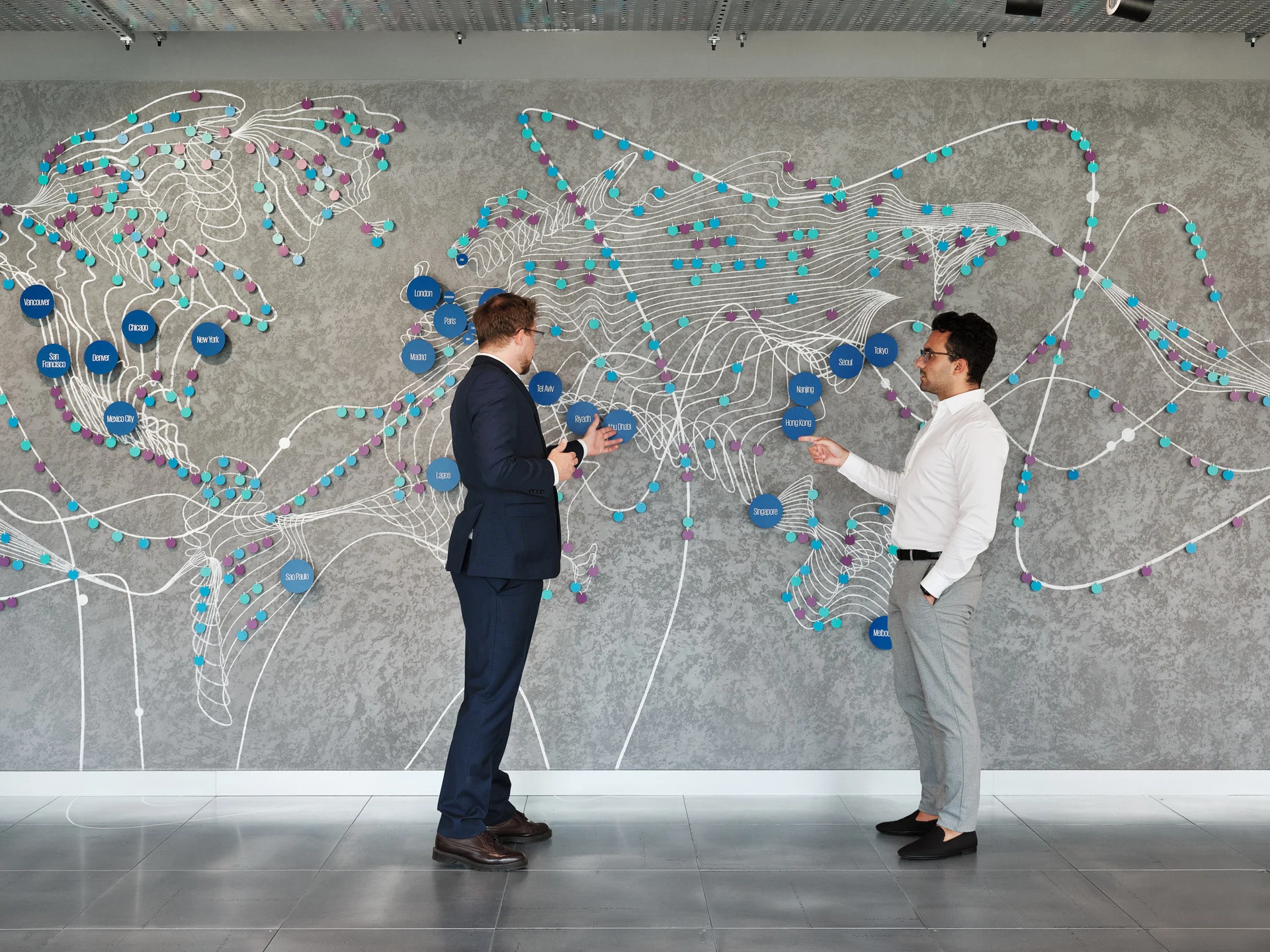 A continuation of the particle-wave, the mural transforms into an abstract world map that celebrates human participation and highlights global Ignition Centers. 