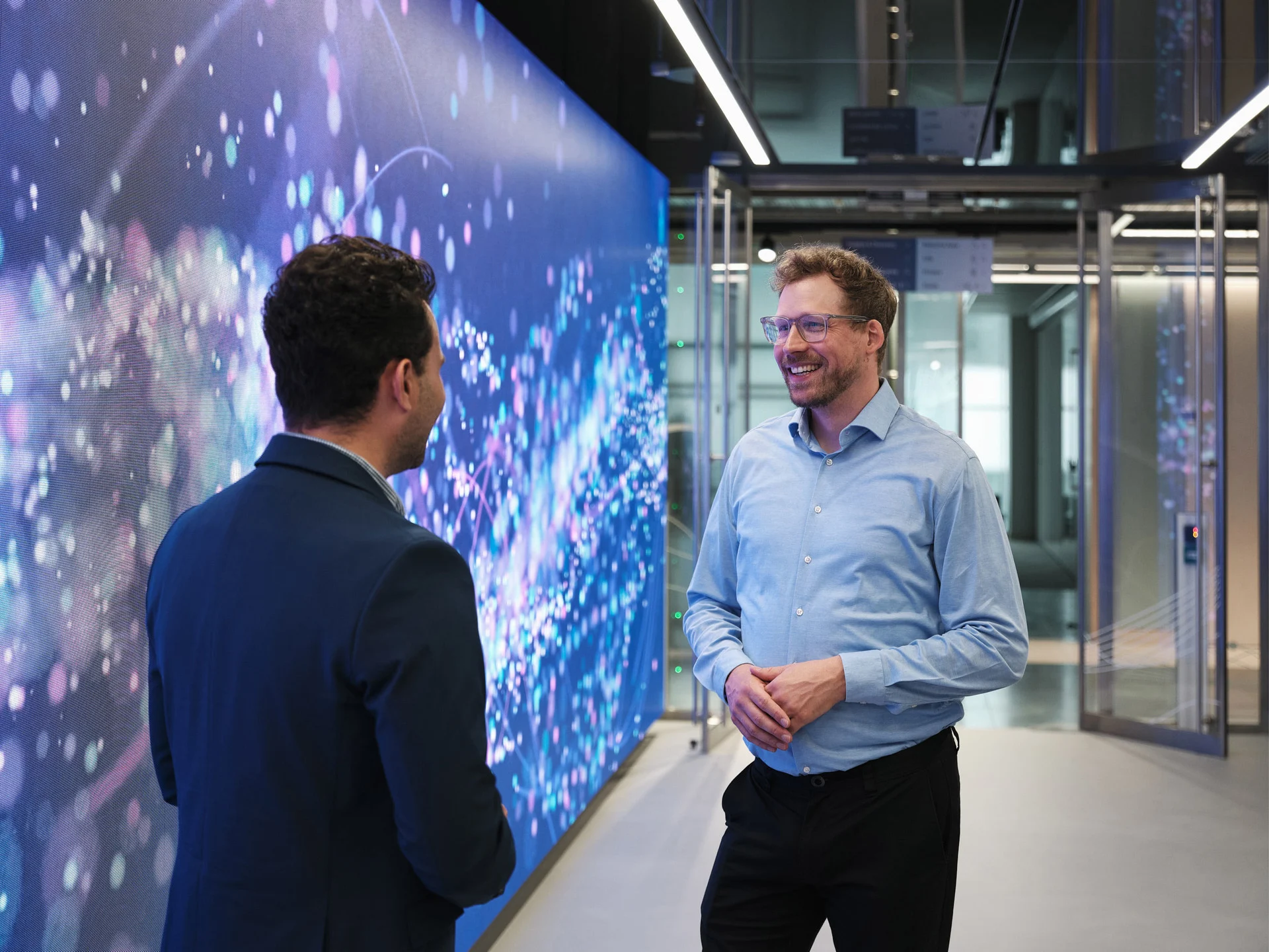 A larger-than-life video wall welcomes visitors as they step out of the elevator into the Ignition Centre lobby.