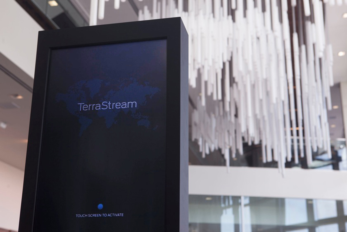 TerraStream’s touch screen kiosk invites visitors to play and explore data visualizations that illuminate across a giant chandelier that manifests an artful map of the world.
