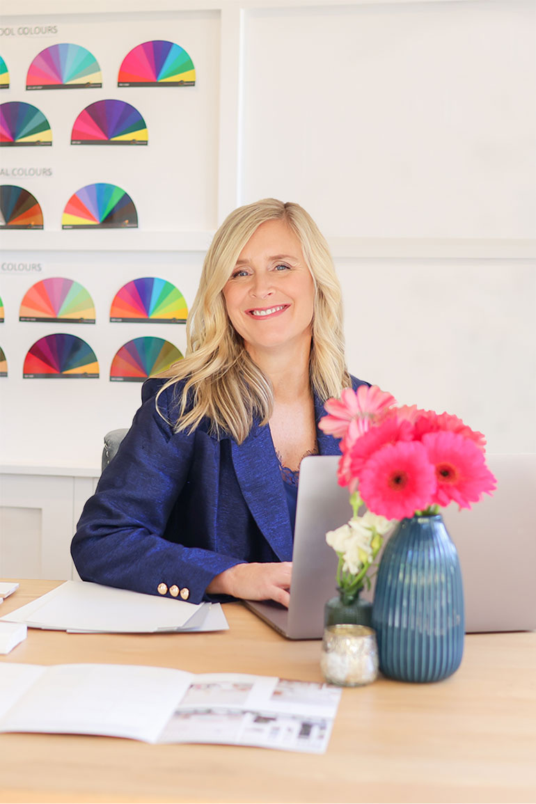 Belle designing on a Macbook