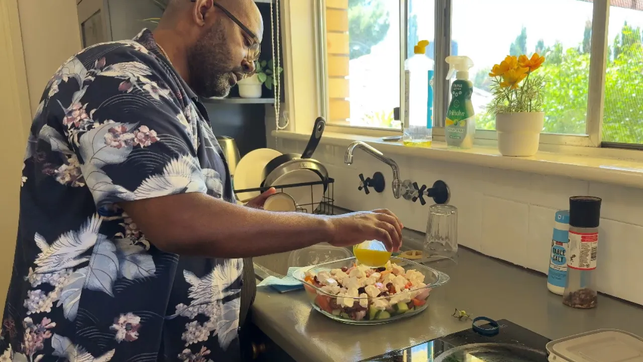 Tenant preparing food in an Iris shared living kitchen in Adelaide