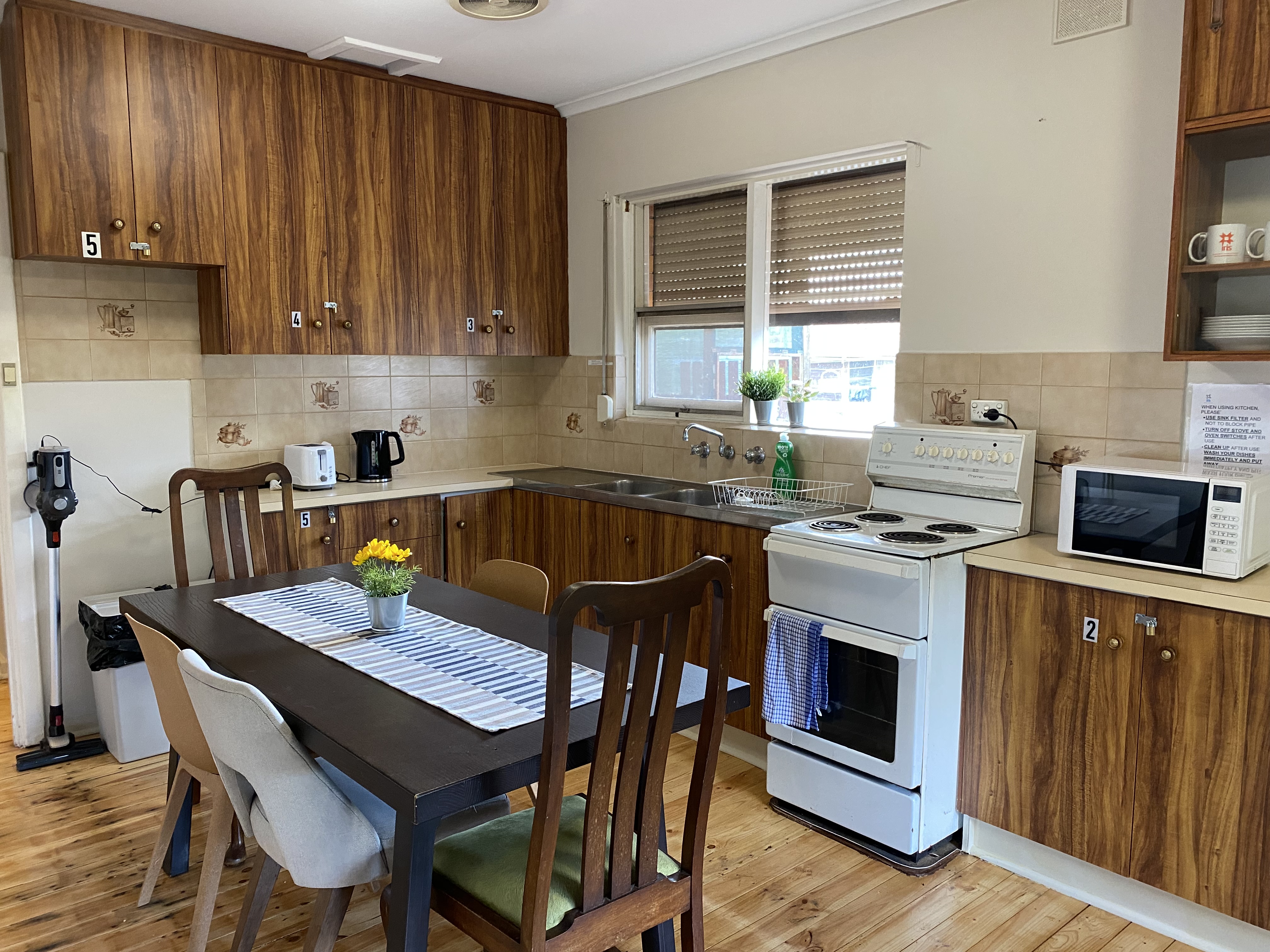 Kitchen with electric stove and dining table