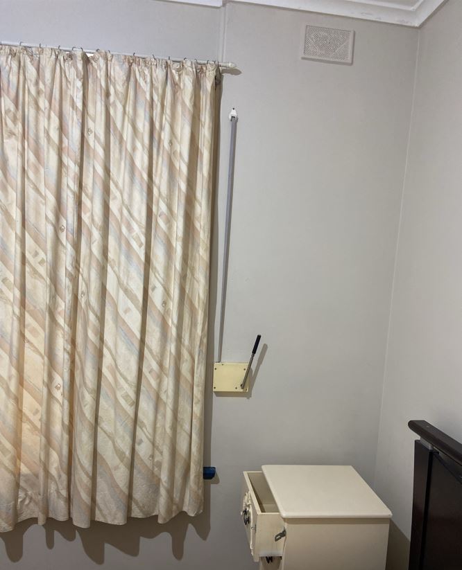 Bedroom with bed, curtain and window light
