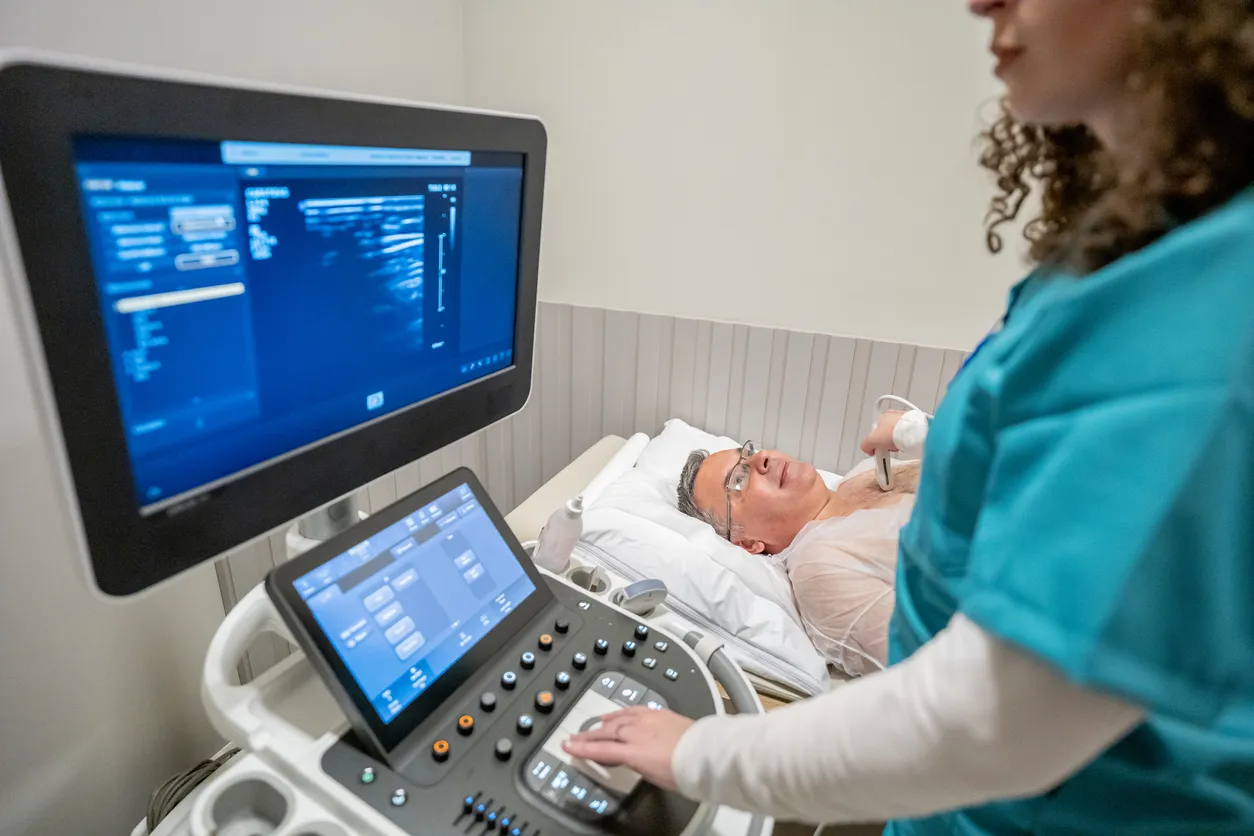 A sonographer performing a cardiac ultrasound on a patient