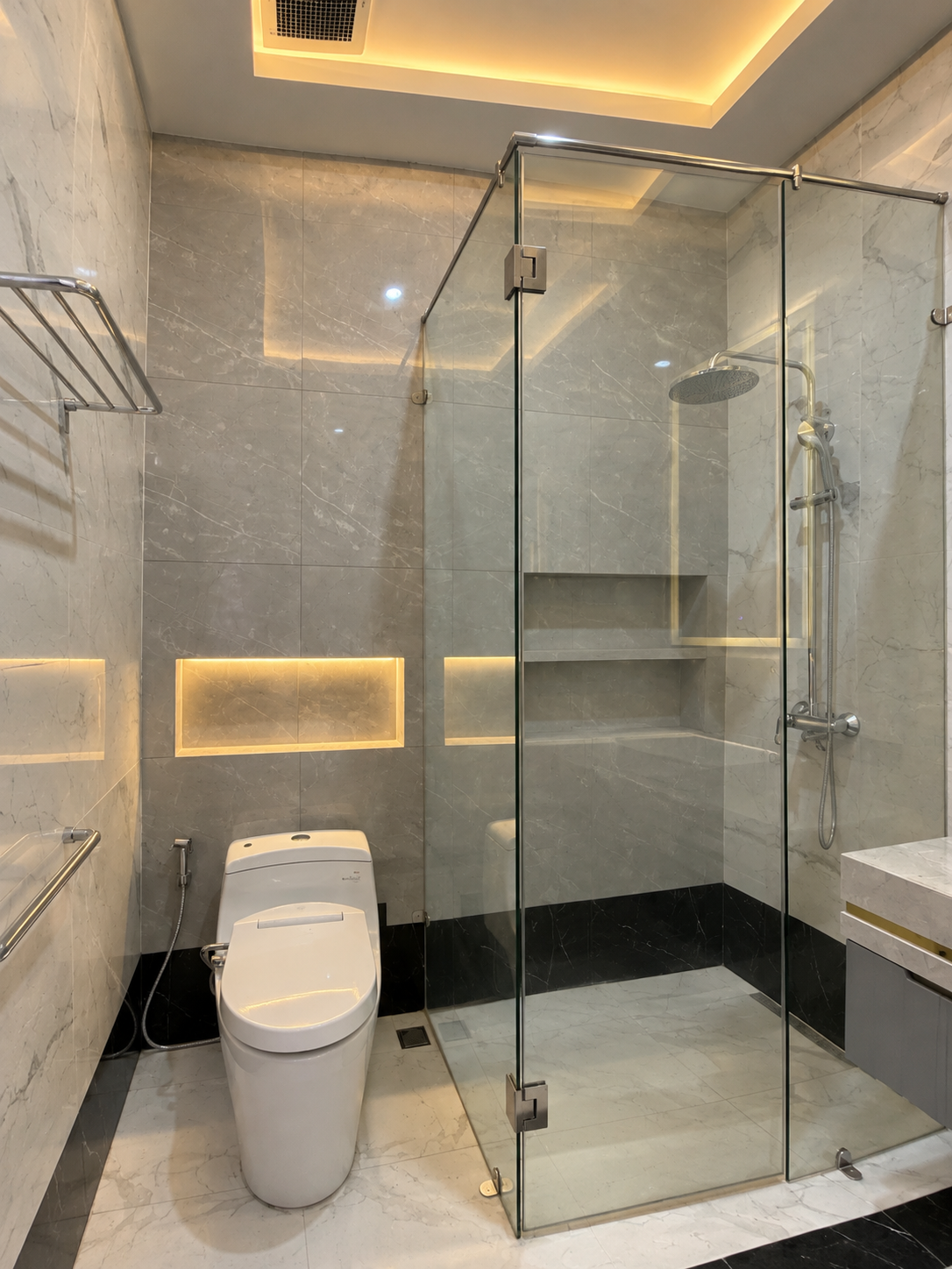 Explore an elegant marble bathroom featuring warm ambient lighting, refined finishes, and a modern luxury design for a timeless, sophisticated space.