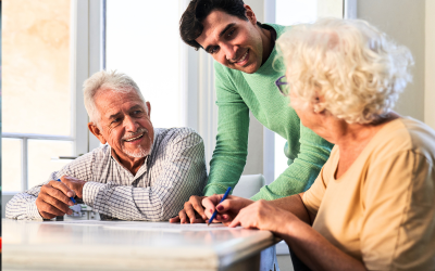 Family caregiver talking with elderly parents at home, completing medical ID details for dementia safety.
