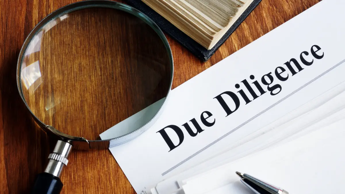 A magnifying glass over a document labeled "Due Diligence," illustrating TPRM due diligence investigation