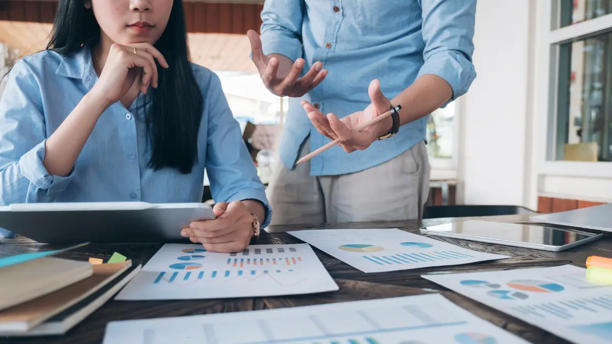 Risk management software displayed through charts and documents during a team discussion for analysis and planning