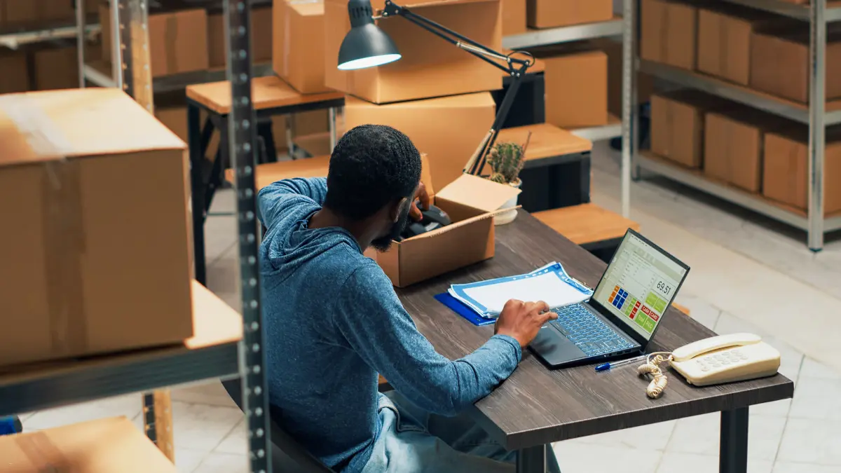 Third-party risk management solutions involving barcode scanning and data entry on a warehouse laptop.