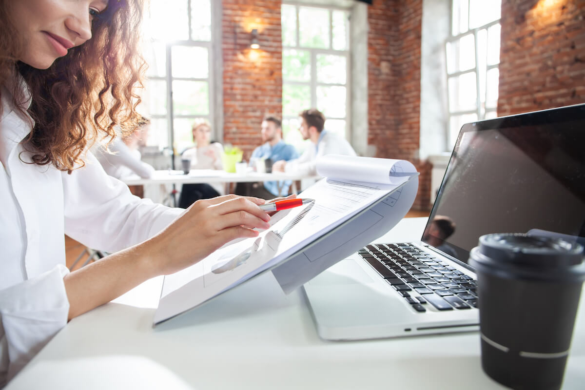 Team member checking her notes in the office