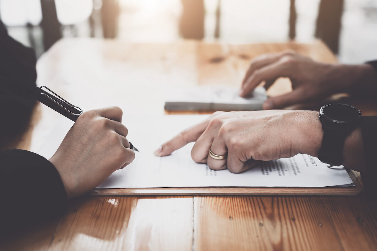 ESG risks: person pointing out something from a contract