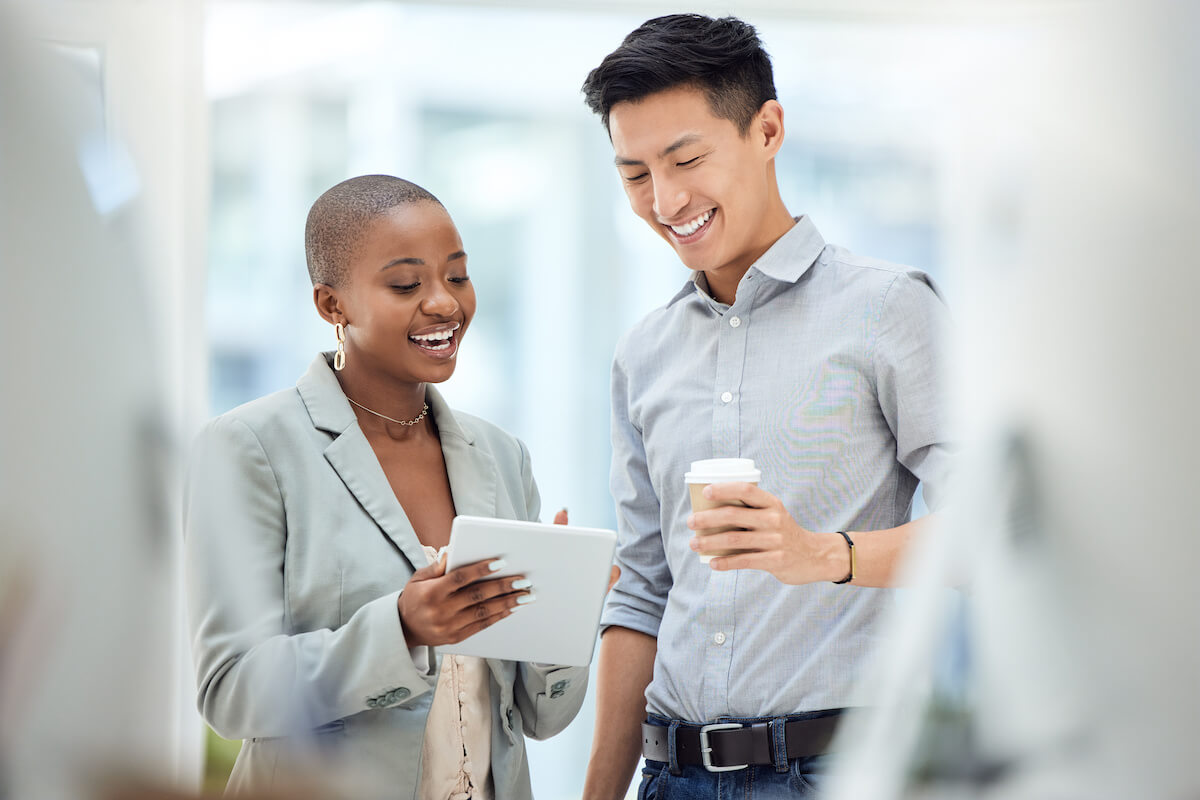 Compliance KYC AML: employees looking at a tablet