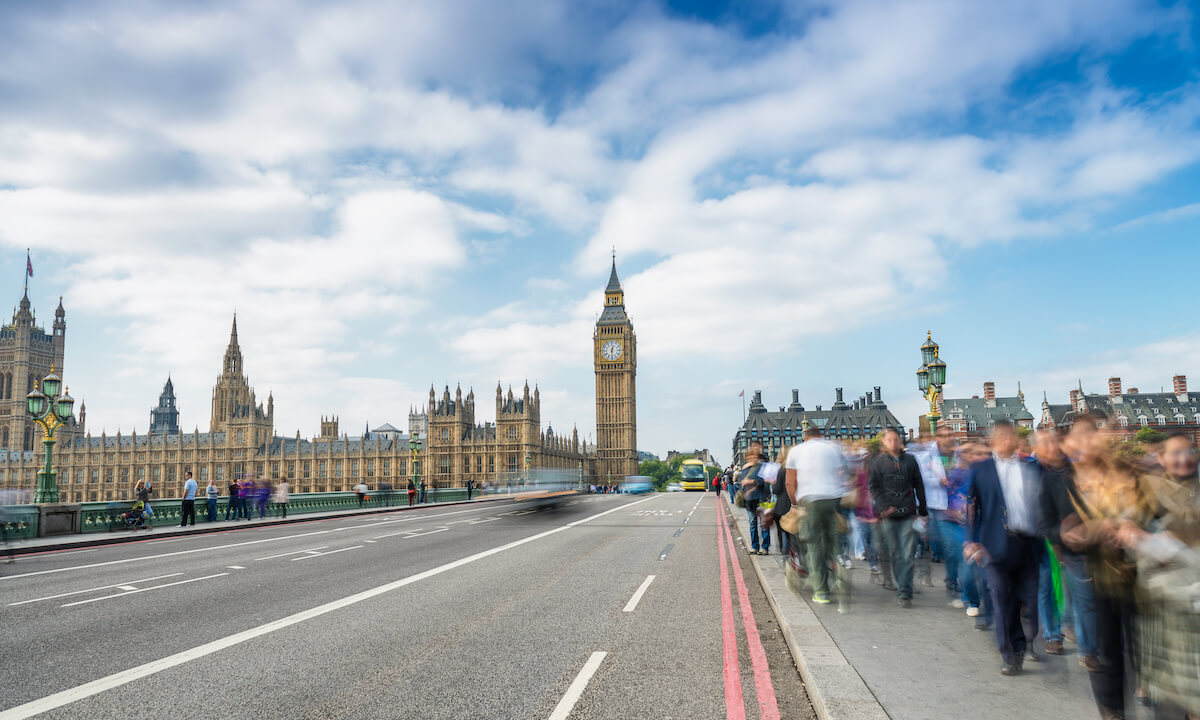 People walking along the Westminster Bridge in London