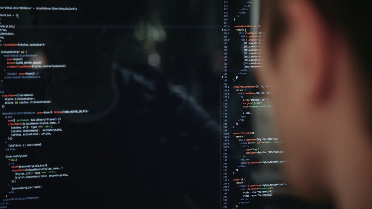 Risk management in banking: programmer looking at codes on a screen