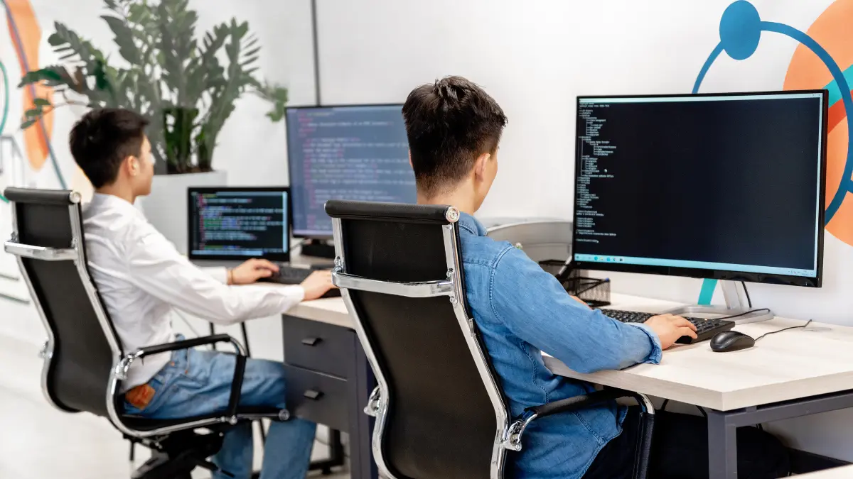 AI for risk management engineers coding automated compliance tools in a modern office setup.