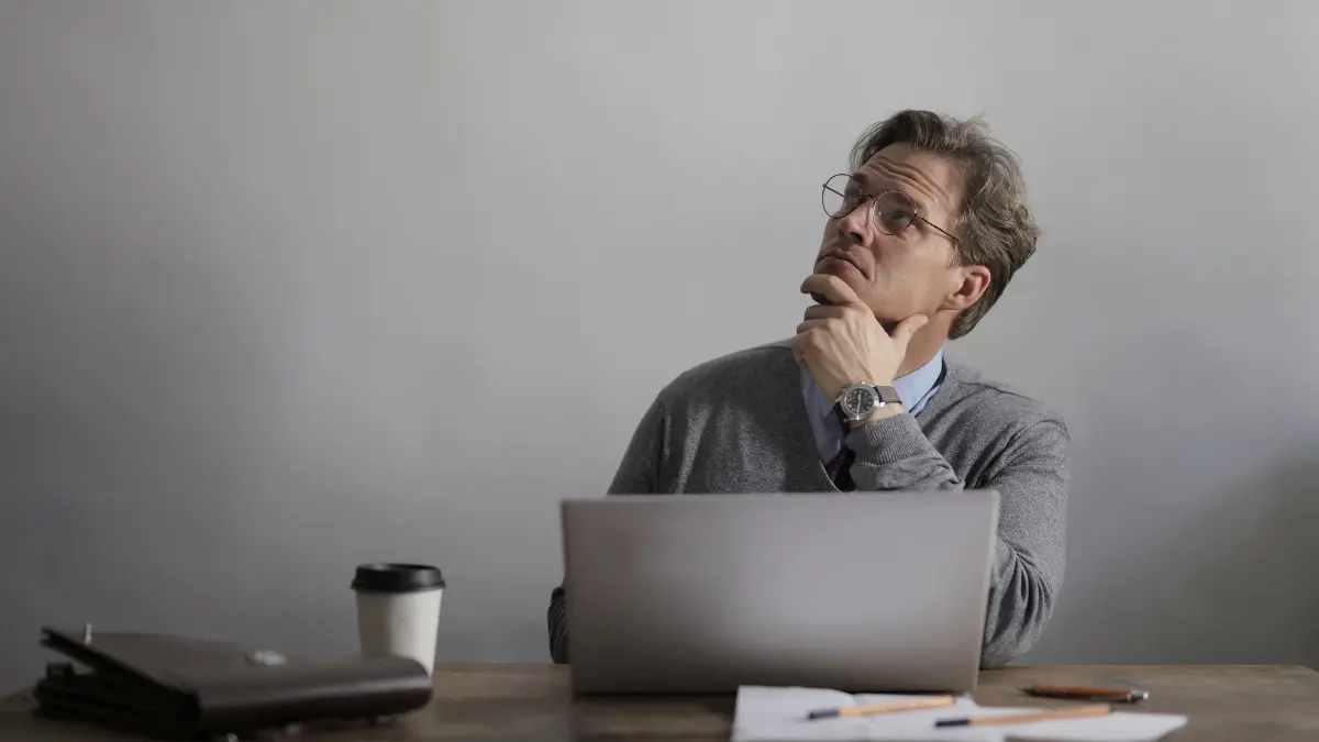 Risk management automation team applauding a successful presentation on charts and analytics in a bright office setting.