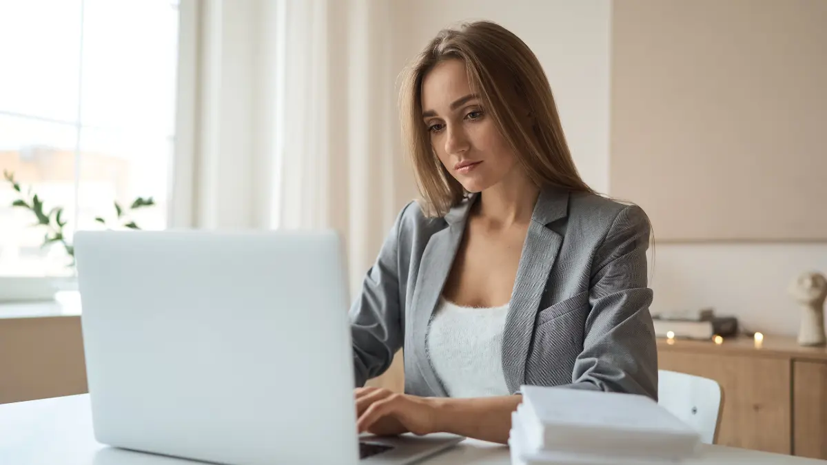 Sustainable procurement strategy reviewed by a businesswoman working on a laptop in a home office setting.