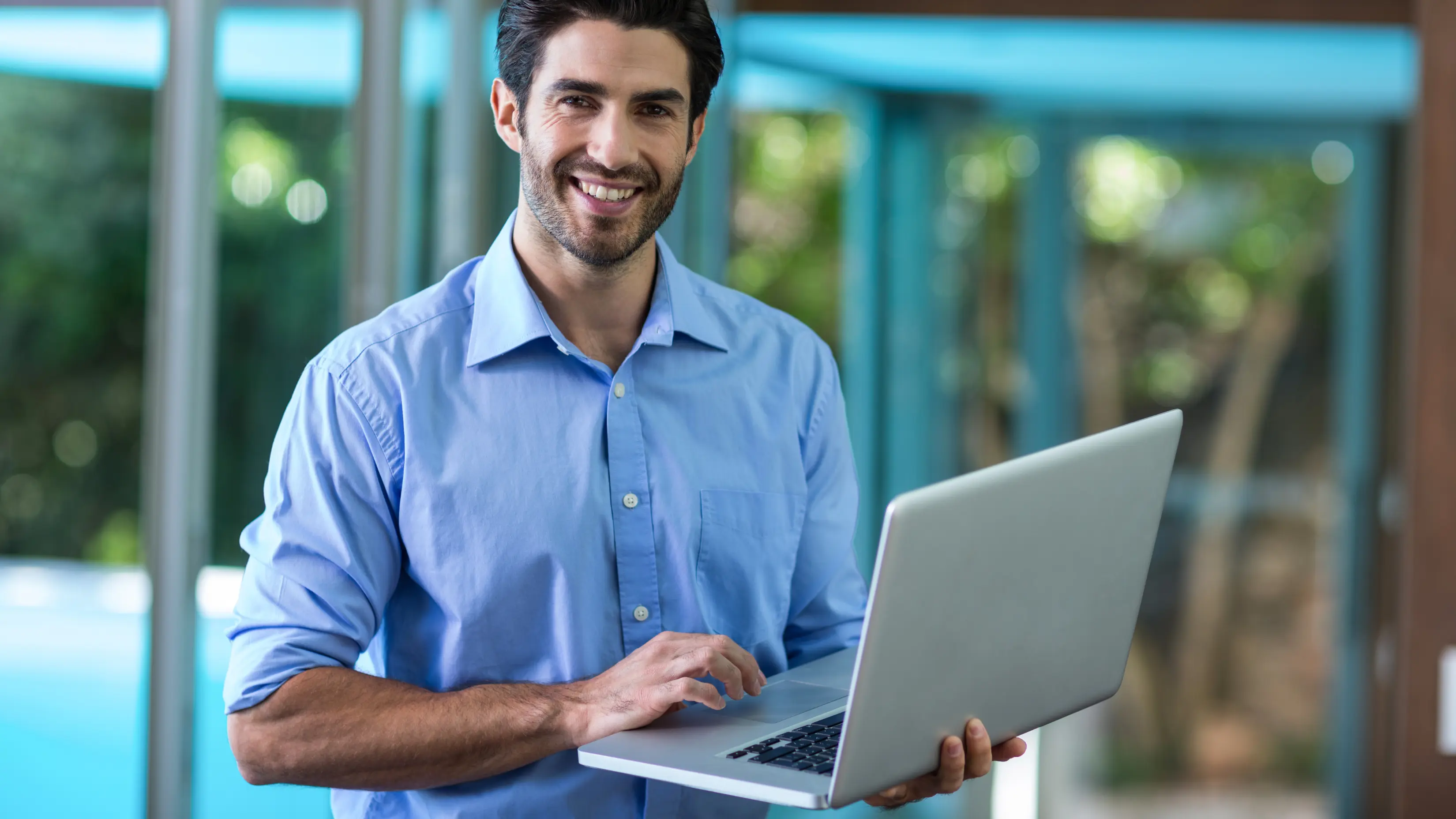 procurement platform showing a business professional using a laptop for digital purchasing and supplier management