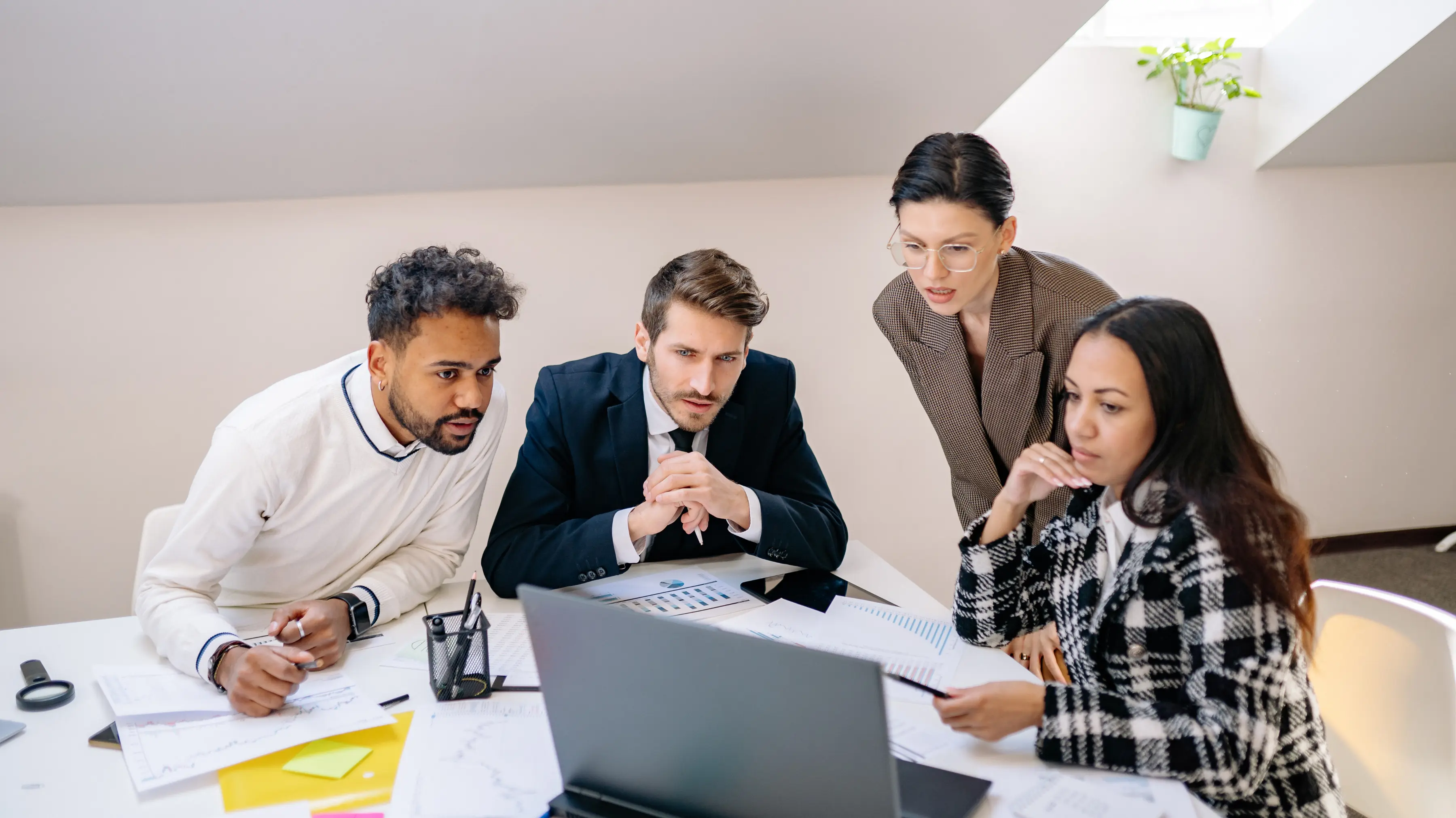 third-party monitoring solutions shown by a business team reviewing vendor performance and analytics on a laptop