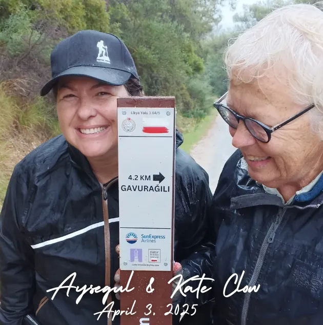 Kate Clow, the creator of the Lycian Way, at the Gavuragili signpost on Turkey’s famous hiking trail. A special moment on the Mediterranean coast path.