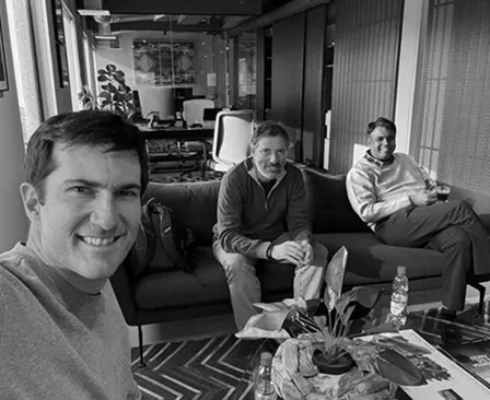 A group of men sitting around a living room table.