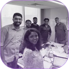 A group of people standing around a table.