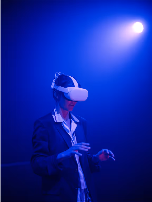 Een persoon in een mooi verlichte blauwachtige ruimte staat, terwijl ze zich in virtual reality bevindt.
