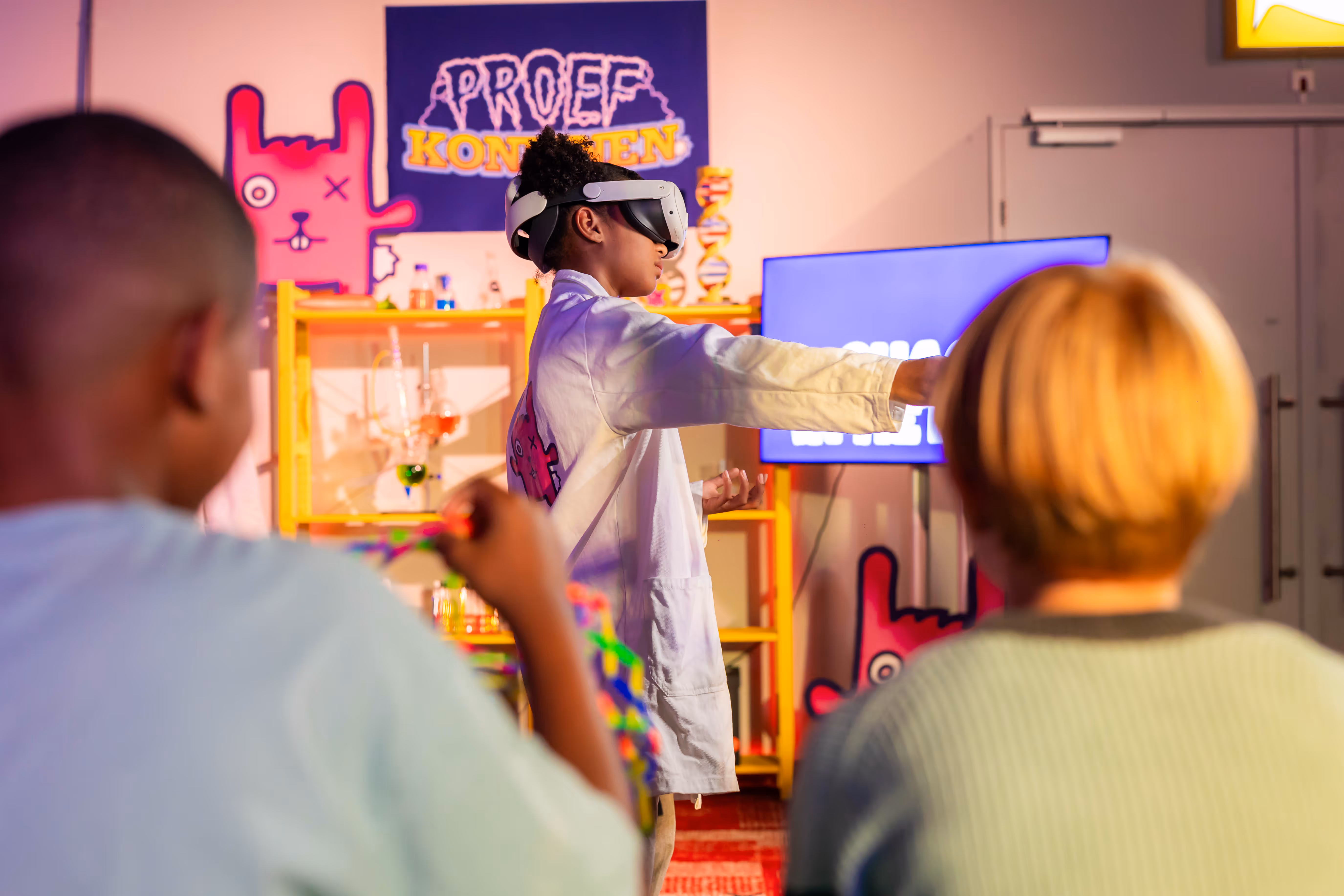 Young participant wearing a VR headset while exploring Chaos in the Lab at Cinekid Festival’s Medialab
