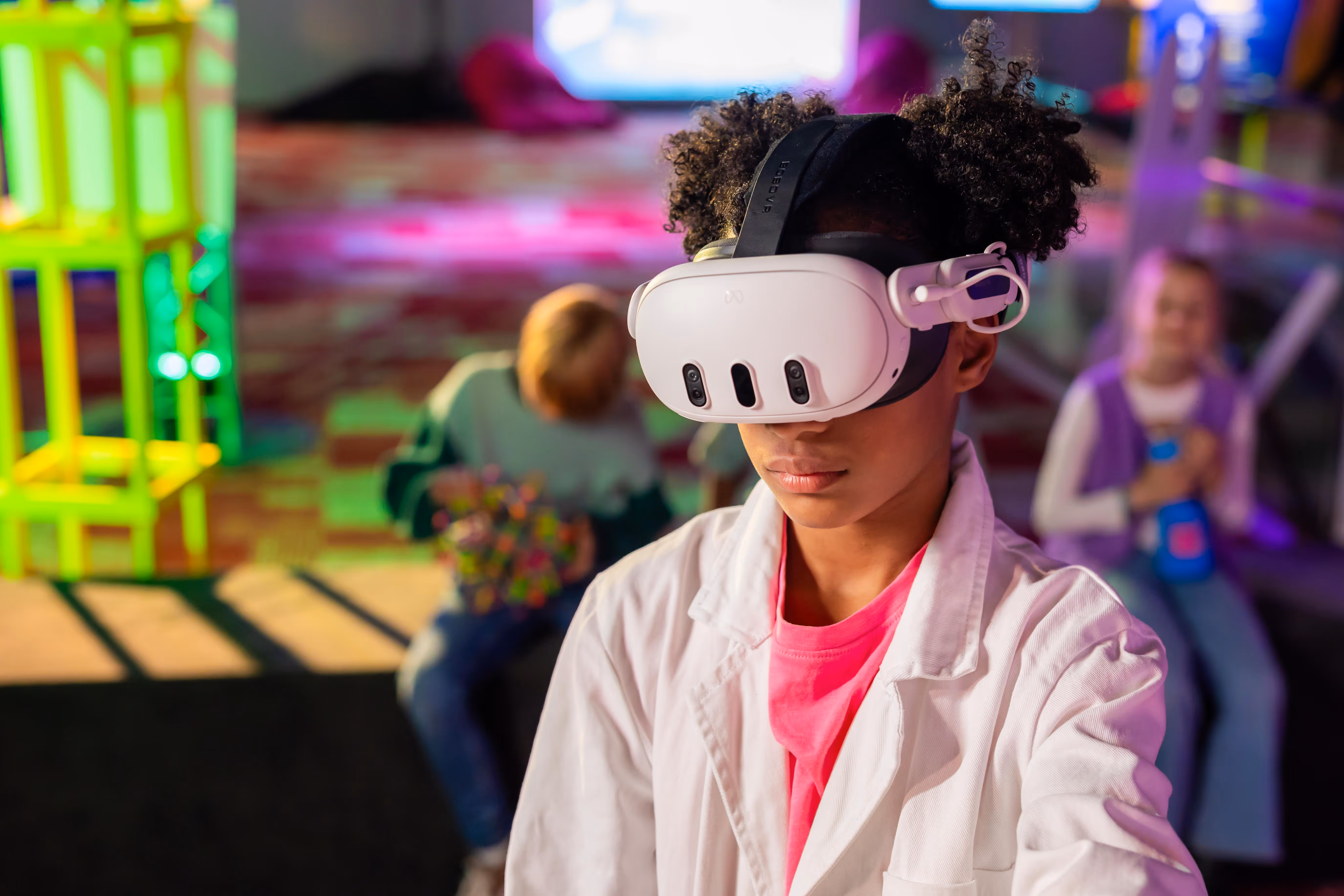 Young participant wearing a VR headset while exploring Chaos in the Lab at Cinekid Festival’s Medialab