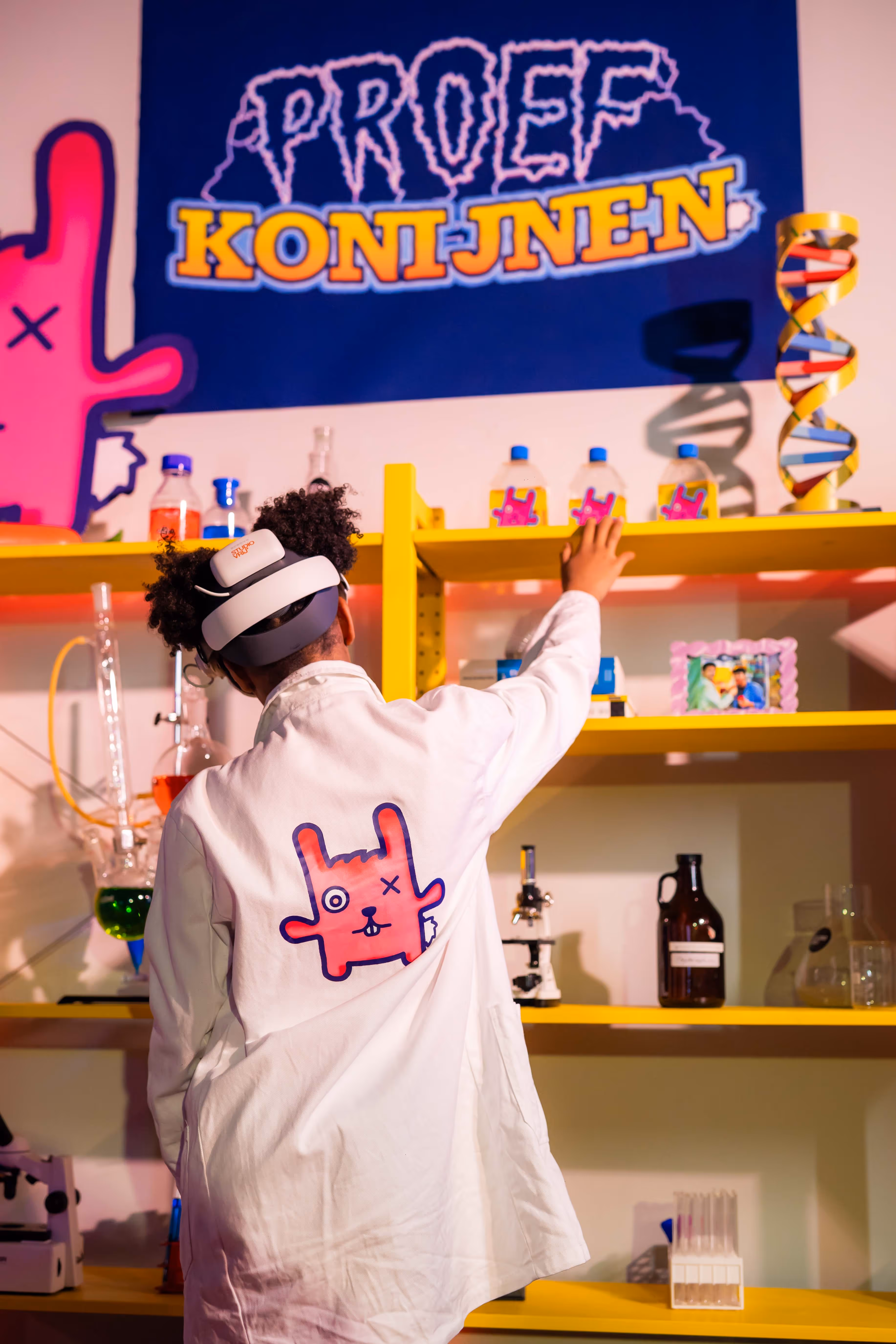 Young participant wearing a VR headset while exploring Chaos in the Lab at Cinekid Festival’s Medialab