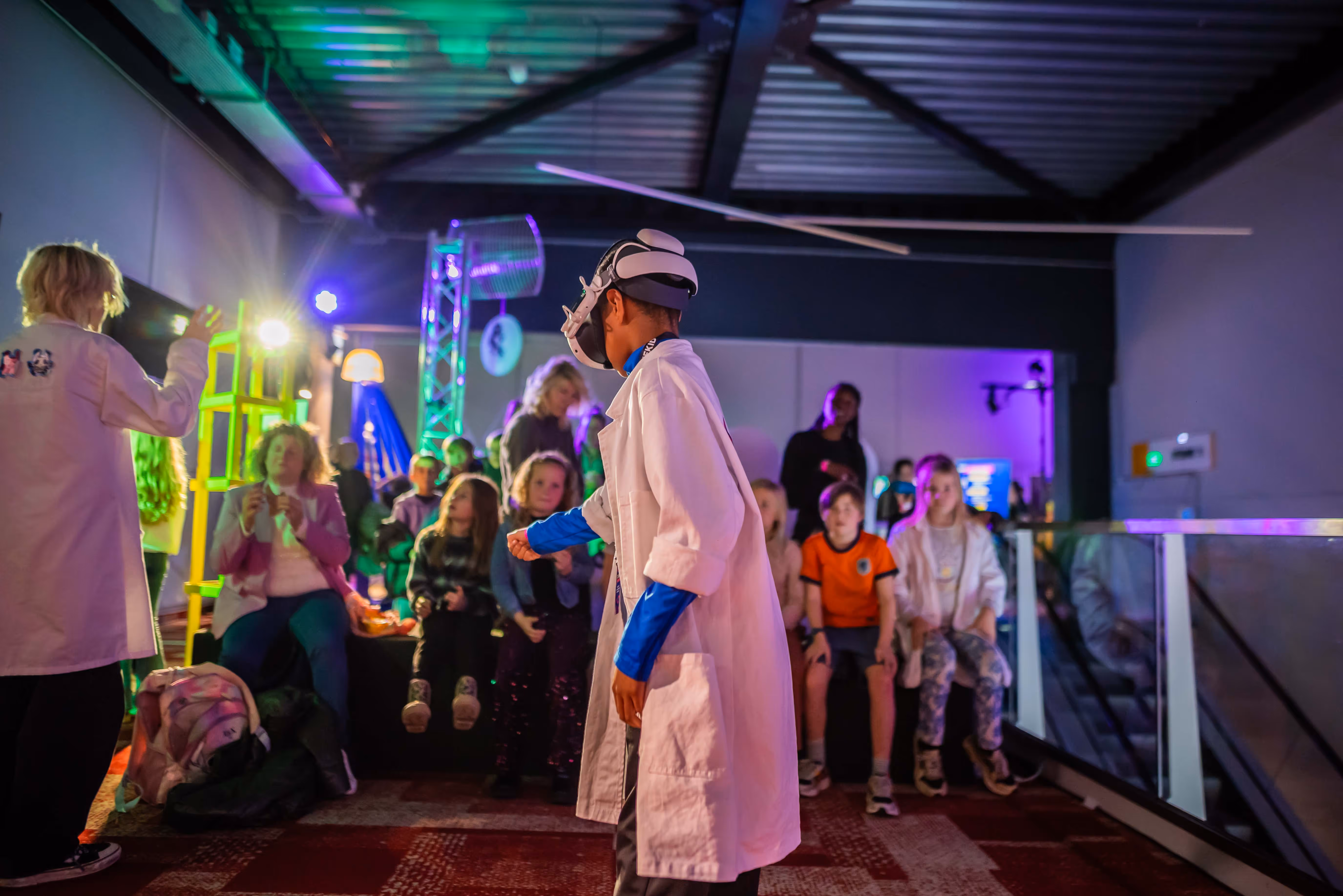Young participant wearing a VR headset while exploring Chaos in the Lab at Cinekid Festival’s Medialab