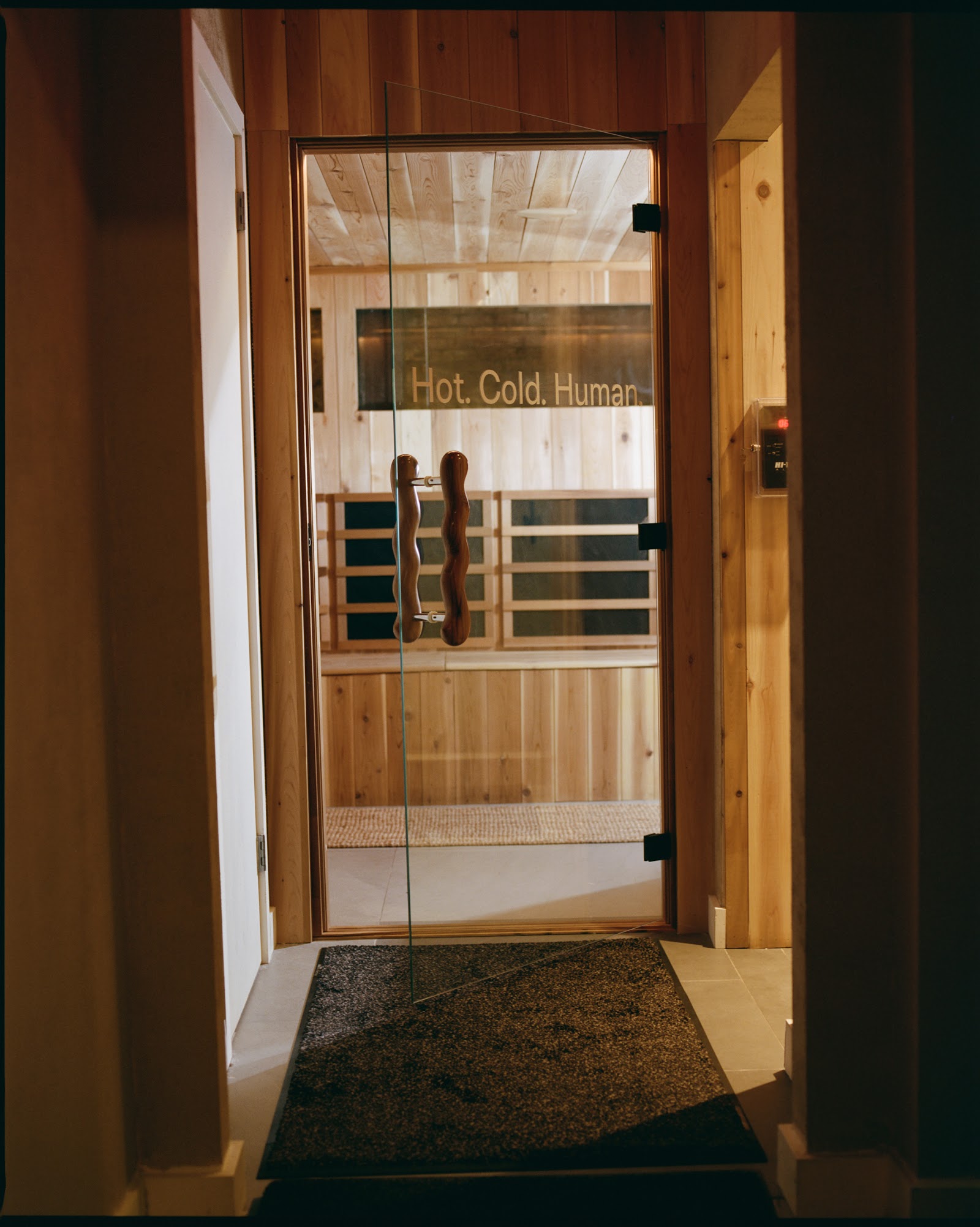 Hot. Cold. Human. — sauna door at Lore Bathing Club