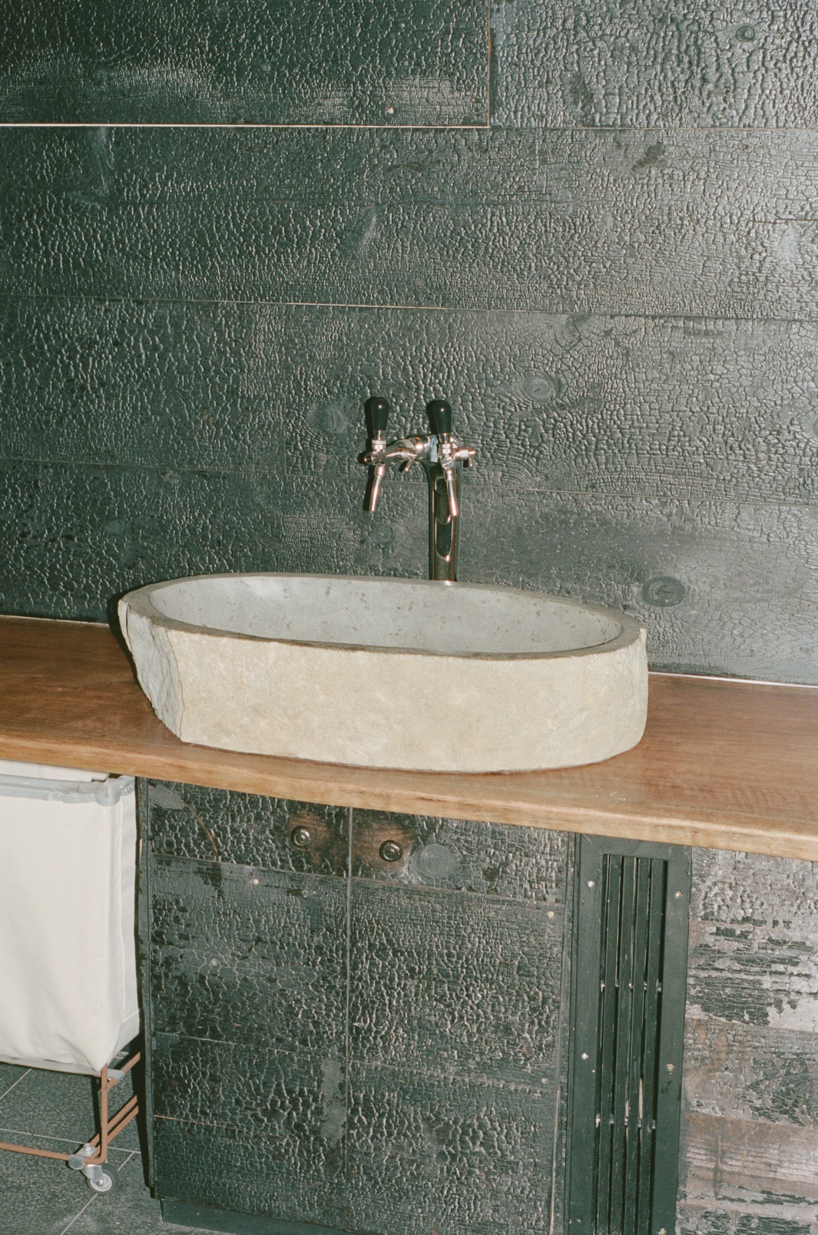 Stone basin with charred wood wall