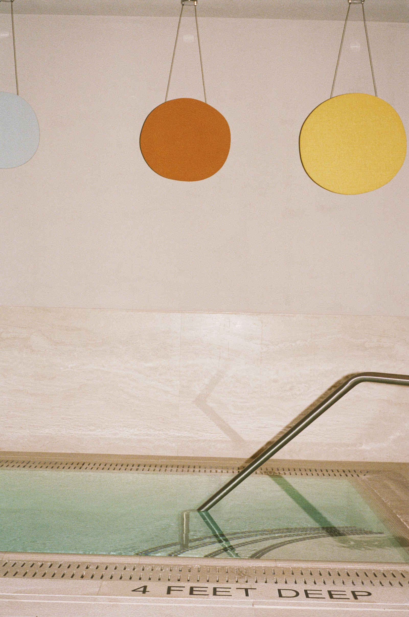 Plunge pool in warm red marble at Lore Bathing Club