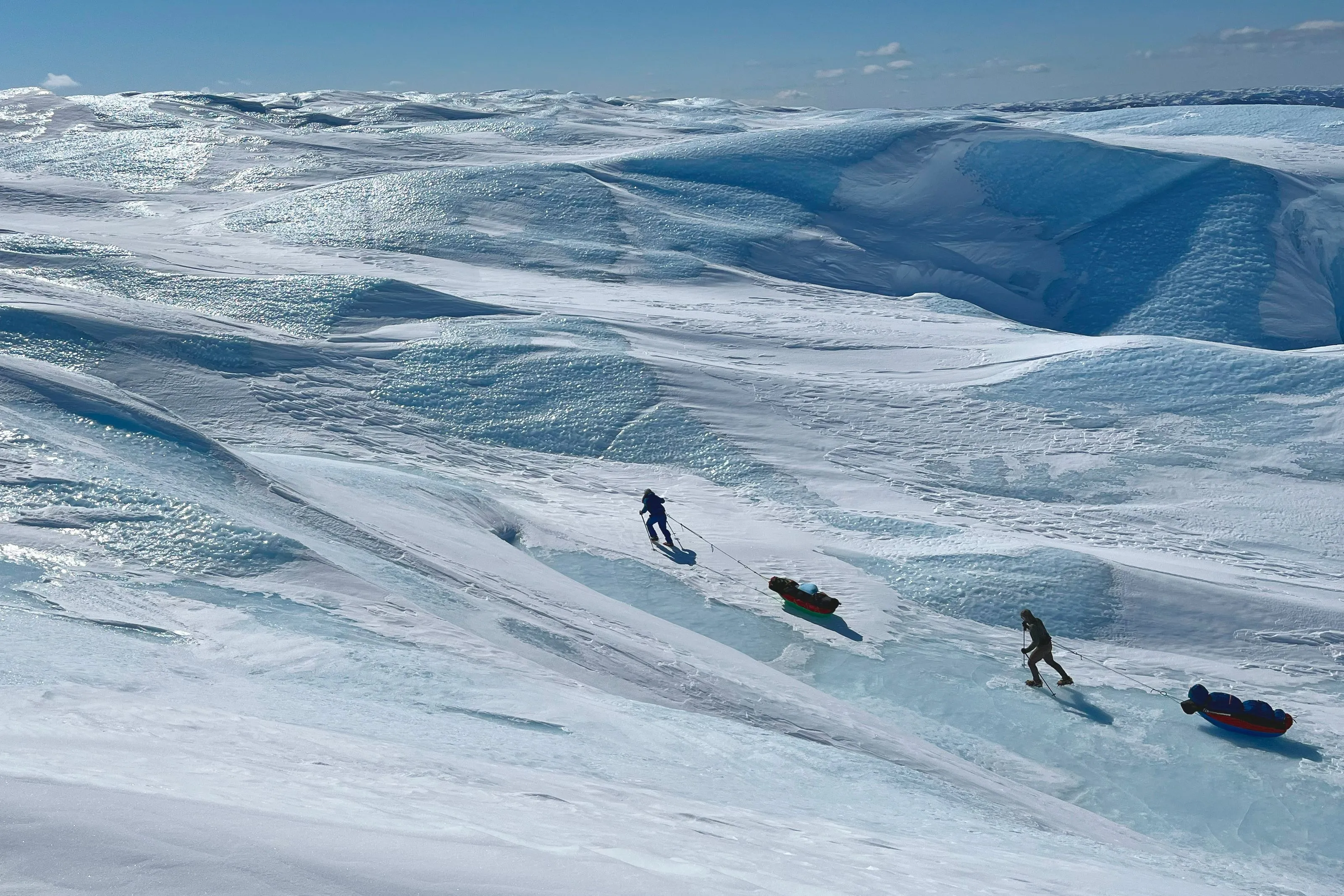 The team hiking up a steep icy slope.