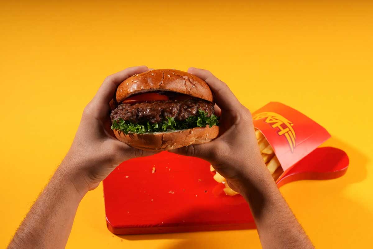 Hand holding a burger