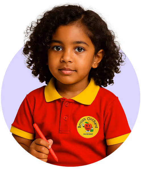 Young girl with curly hair wearing a red and yellow British Orchard Nursery shirt holding a red crayon.