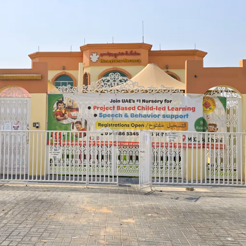 Front view of HoneyBuns Nursery with a large banner promoting project-based child-led learning and speech behavior support, and open registrations.