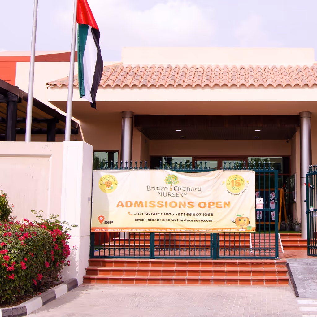 Entrance of British Orchard Nursery with a banner announcing admissions open and contact details, located in DIP.