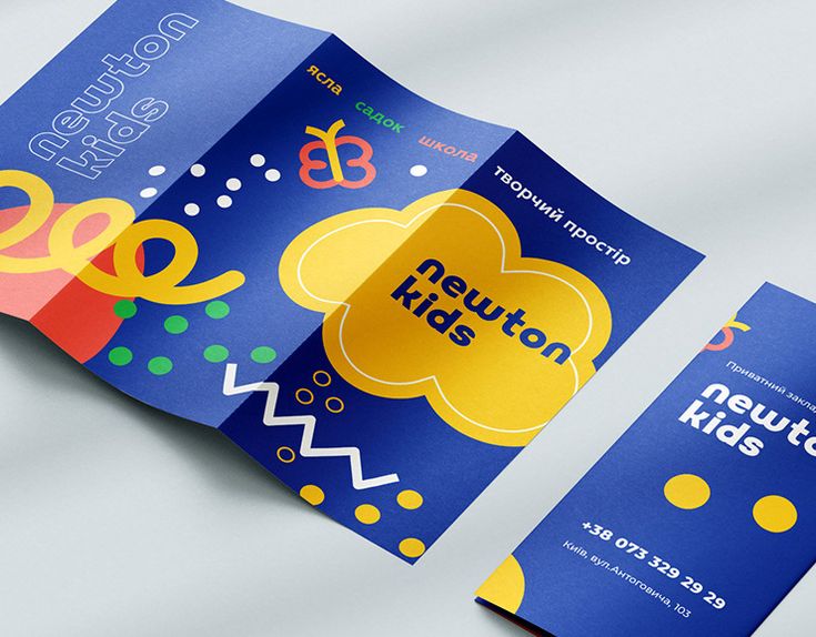 This may contain: an open brochure is displayed on a white surface with blue and yellow colors