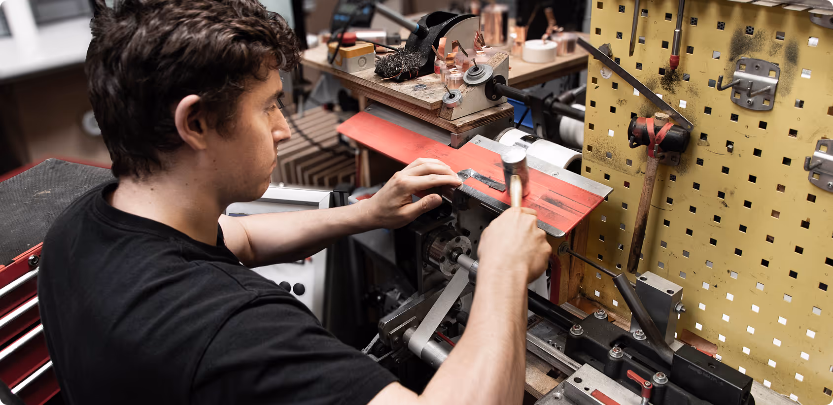 Employee winding coils at the workbench