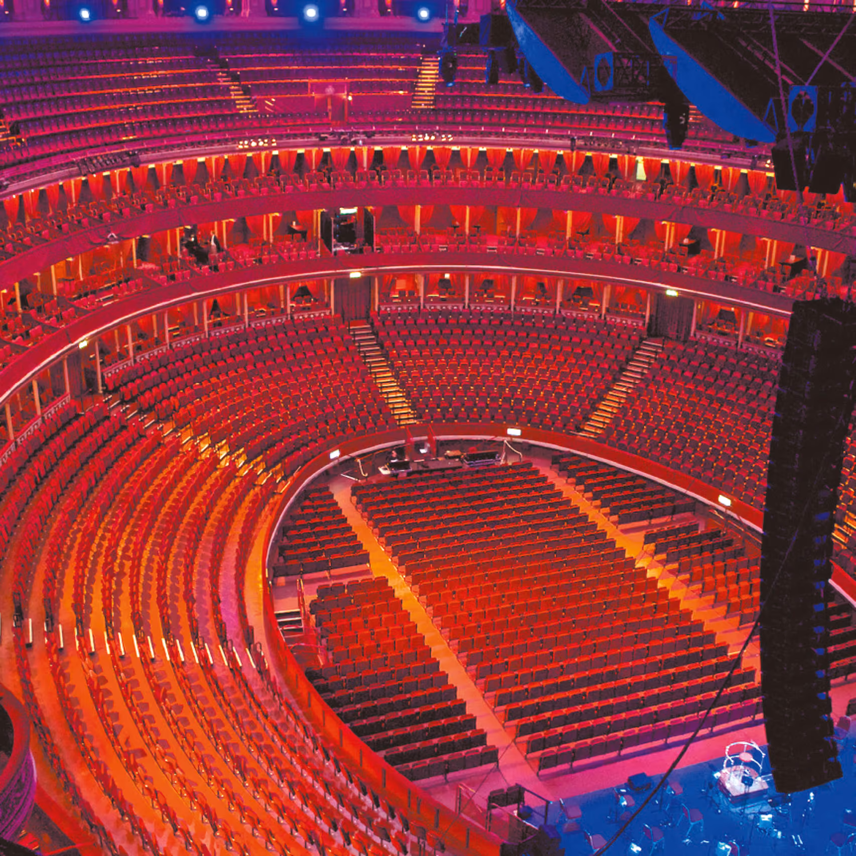 Concert hall with red-lit tiers seen from above