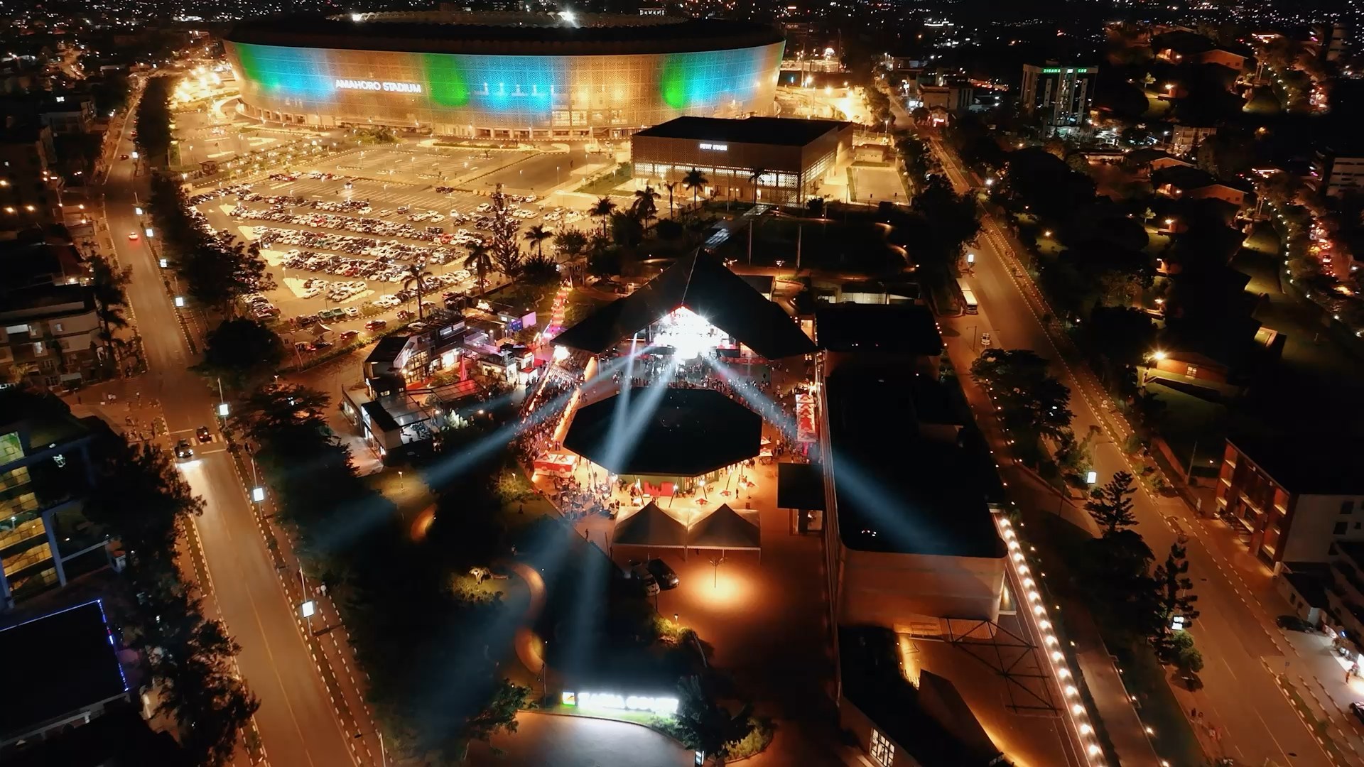 Aerial night view of Zaria Court Kigali lit up beside Amahoro Stadium