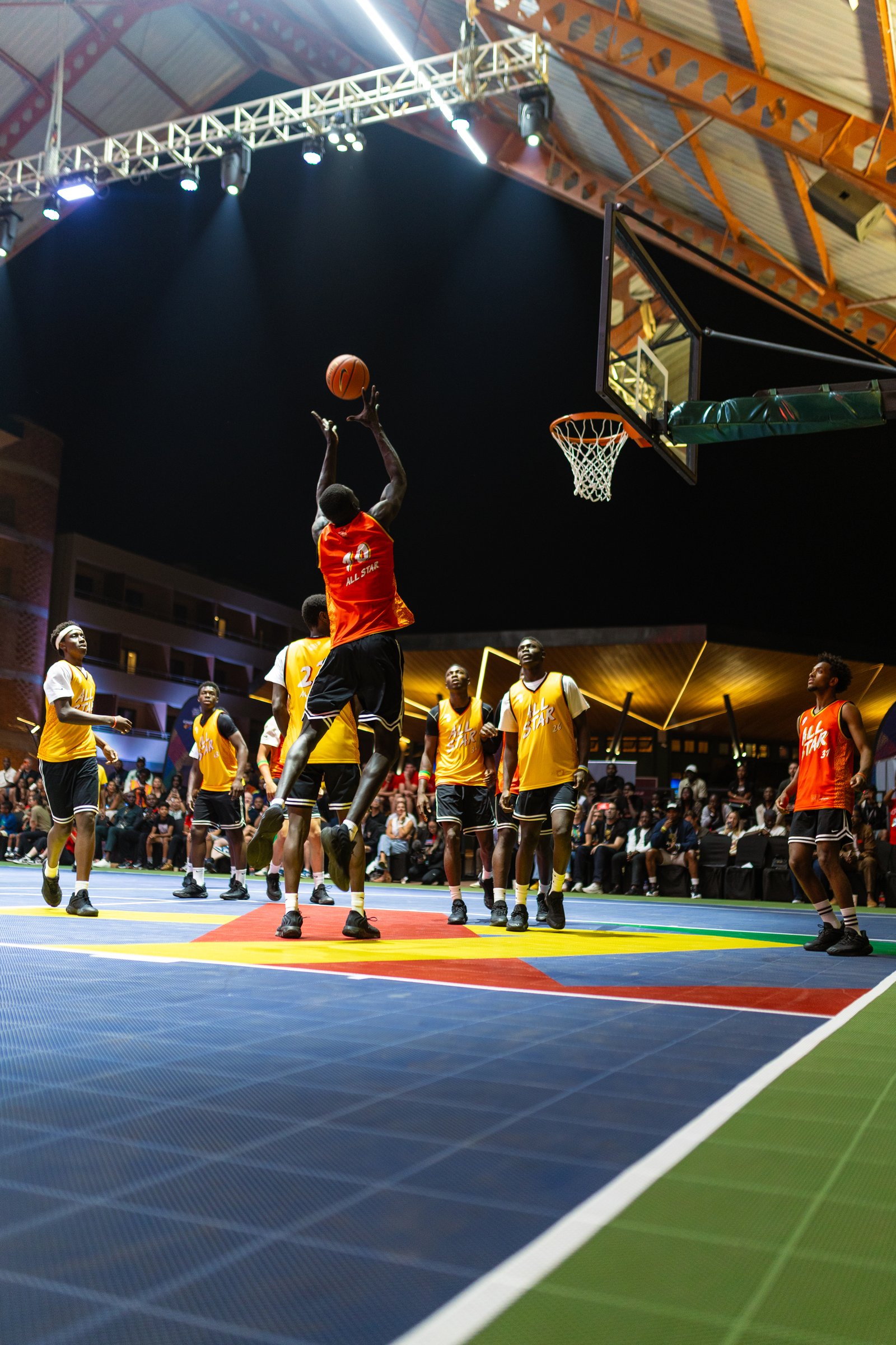 Player rising for a dunk during a basketball game on the court at Zaria Court Kigali