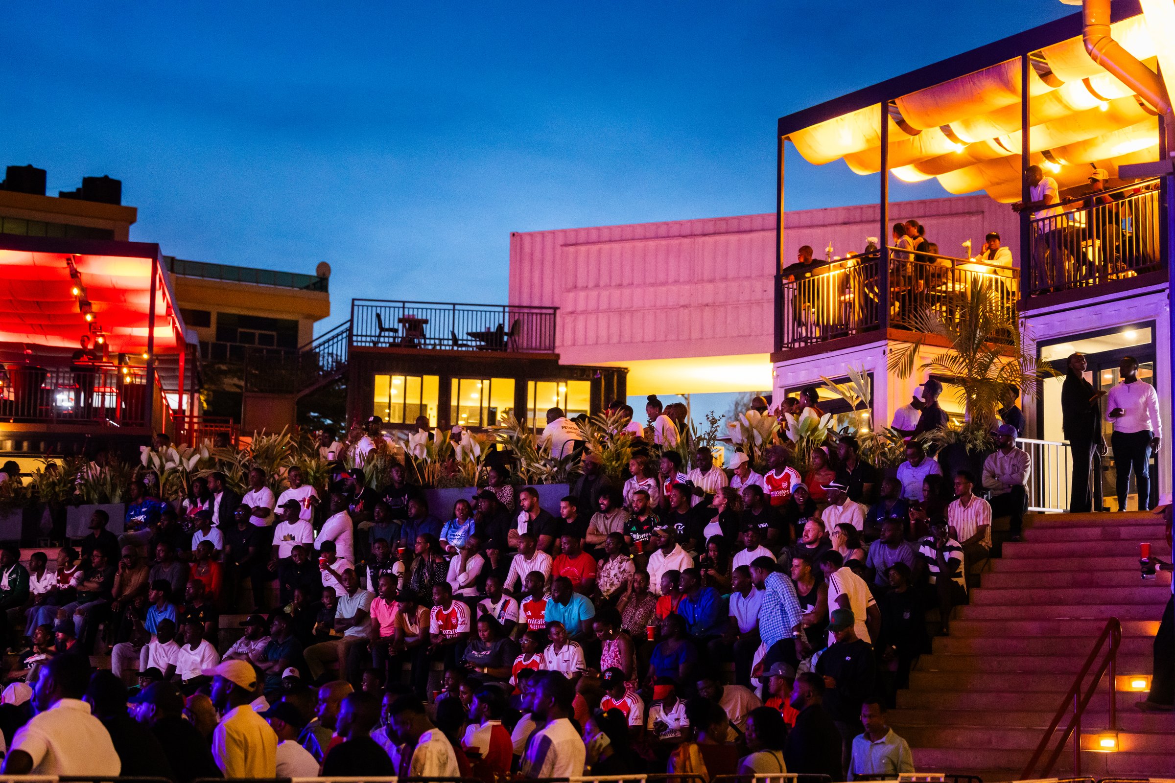 Crowds filling the shipping container retail park at Zaria Court Kigali at dusk