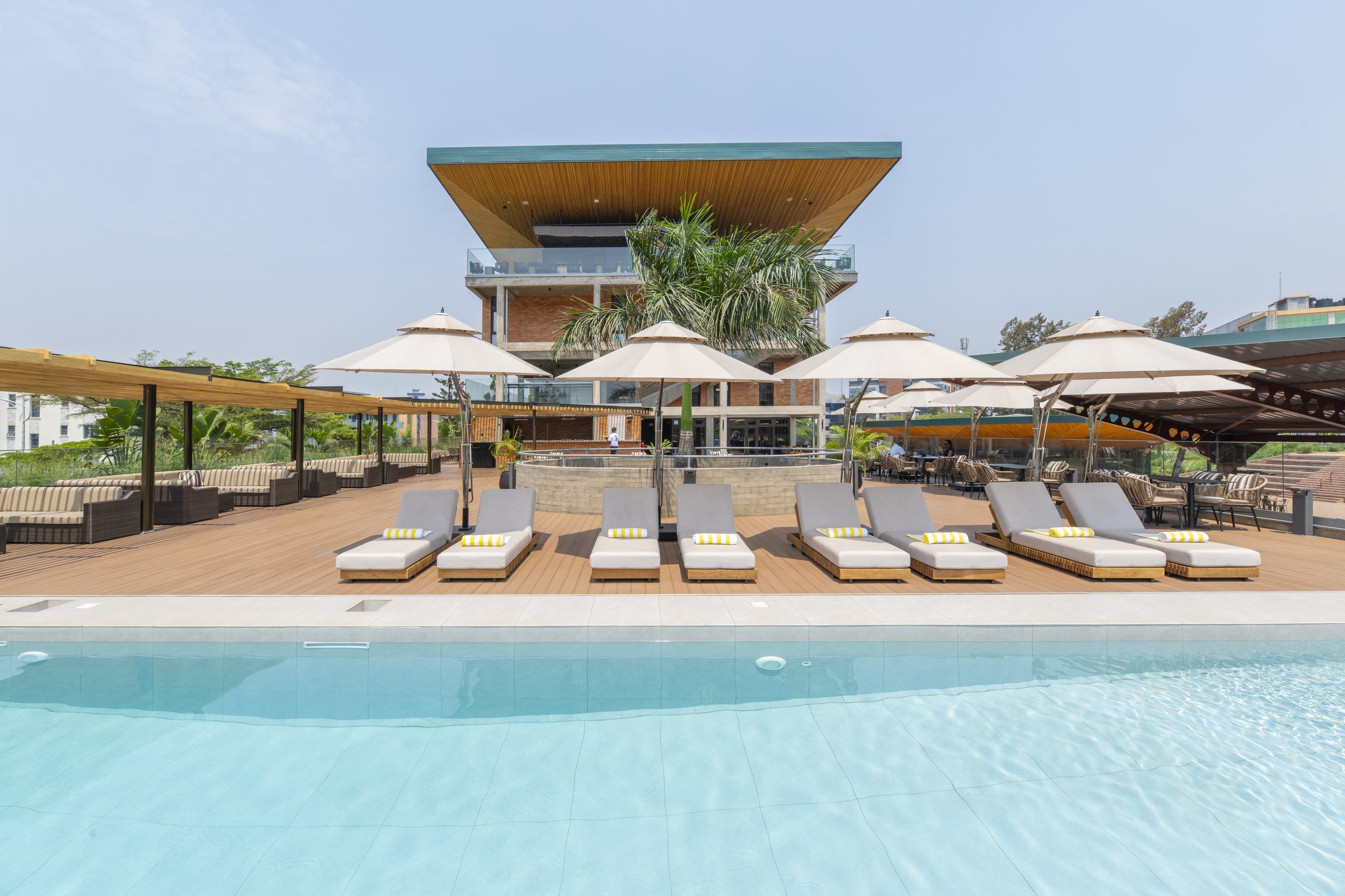 Loungers and umbrellas beside the outdoor pool at Zaria Court Kigali