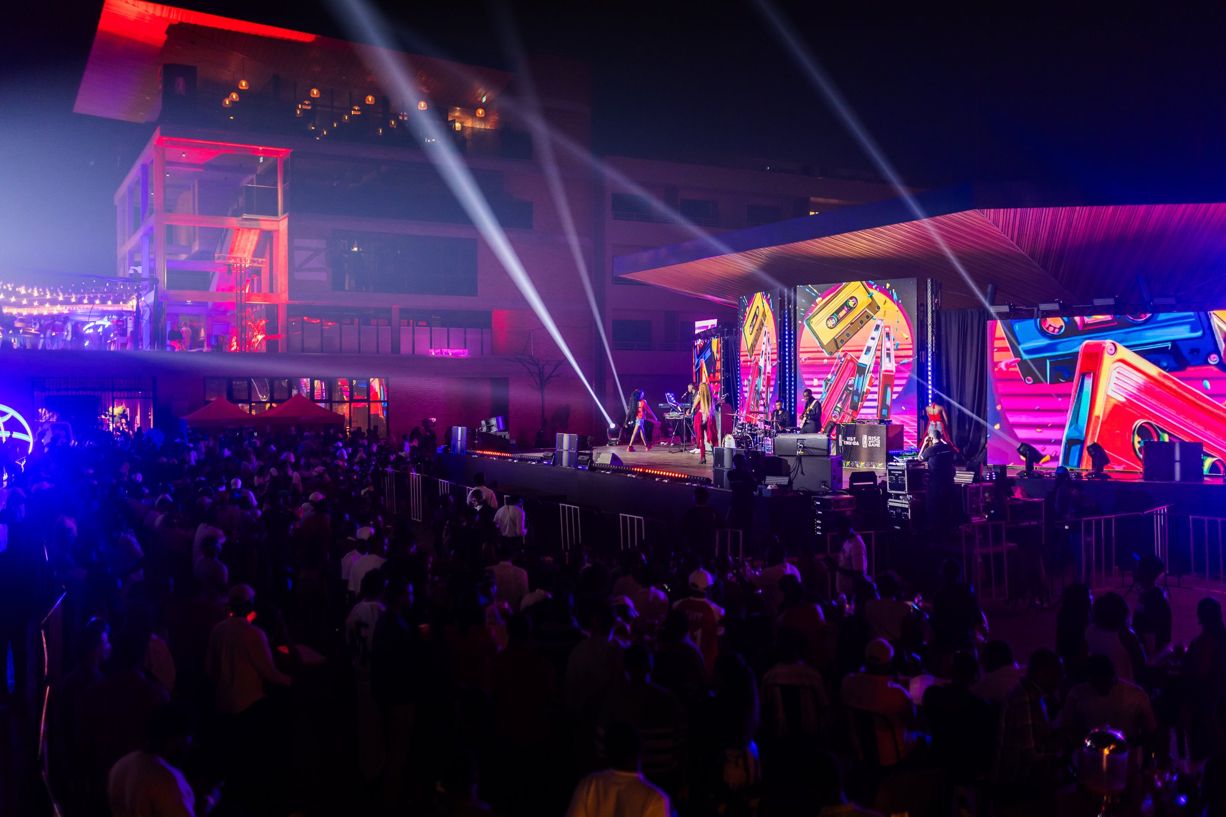 Crowd watching a live concert with stage lasers at Zaria Court Kigali