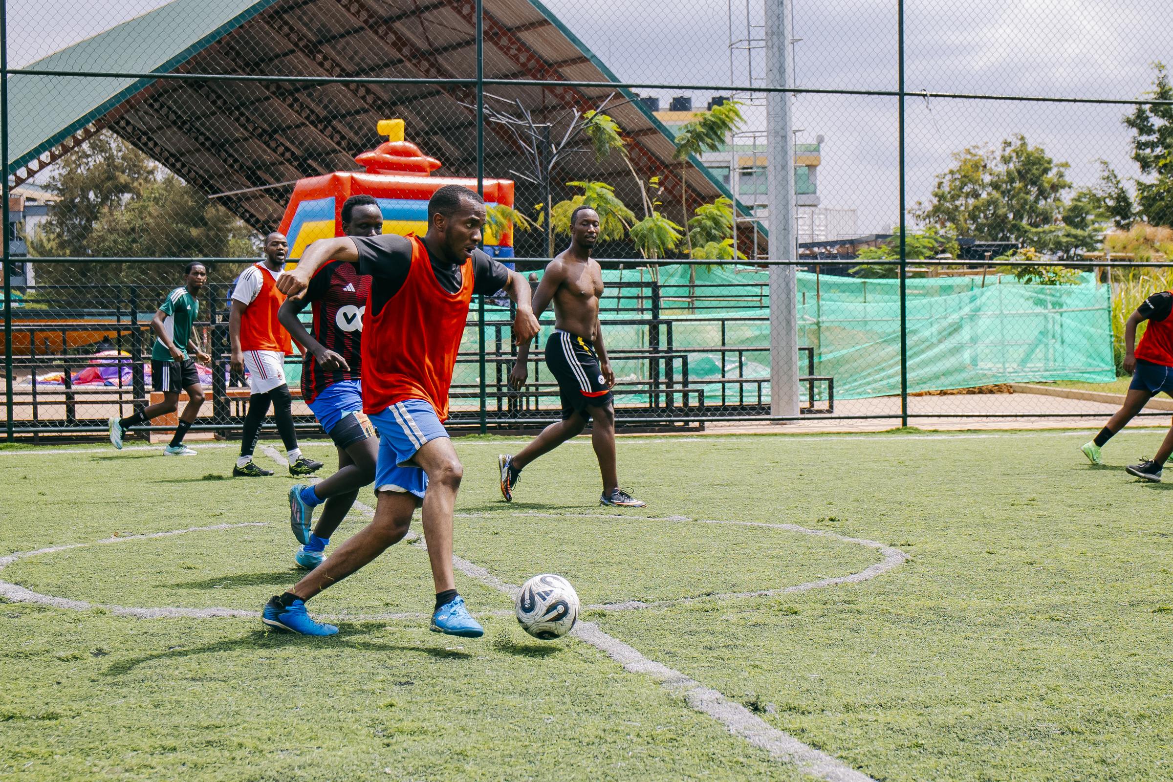 Five-a-side football match in progress on the pitch at Zaria Court Kigali